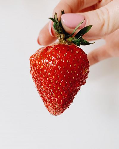person holding strawberry