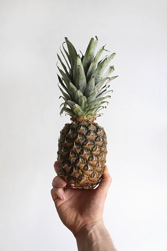 person showing pineapple fruit