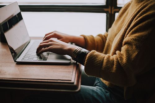 person sitting front of laptop