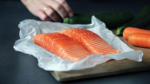 raw fish meat on brown chopping board