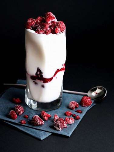 red raspberries on clear drinking glass