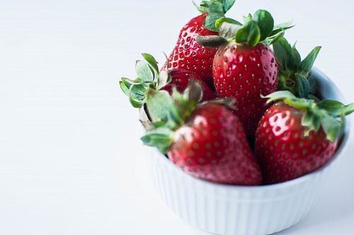 red strawberries in white ramekin