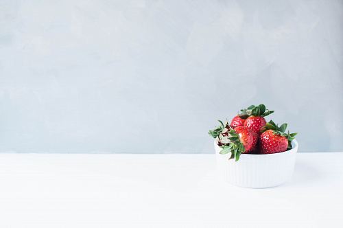 red strawberries on white round bowl