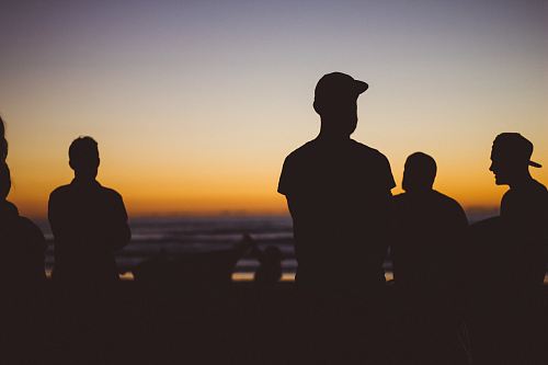 silhouette group of people under sunset