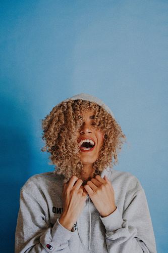 smiling woman wearing gray hoodie