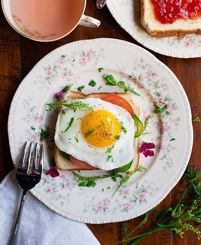 sunny-side up egg with bread beside fork