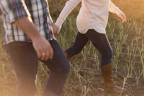 two person wearing denim pants on grass field