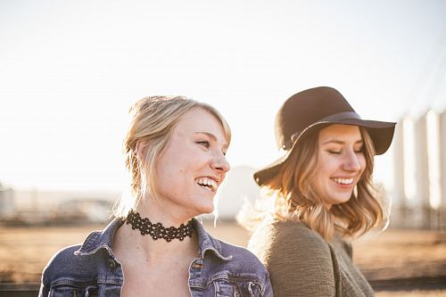 two woman taking a sideview selfie