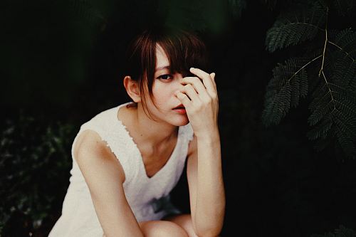 vignette photography of woman in white sleeveless dress
