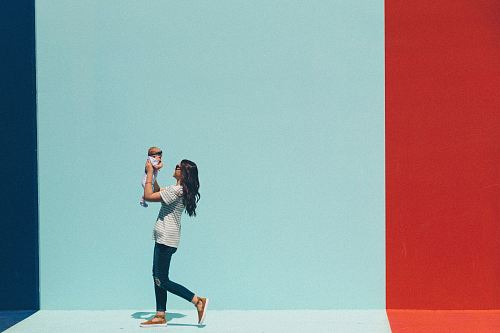 woman carrying baby while walking