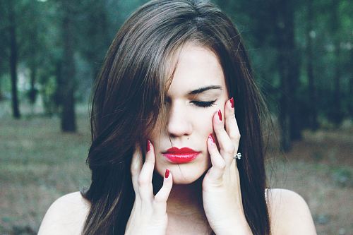 woman holding her face