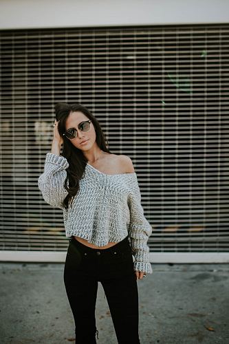 woman holding her head while standing