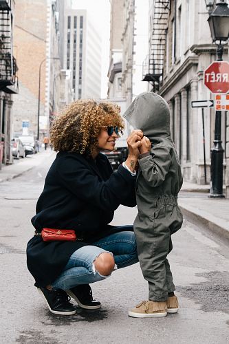woman holding kid at the street