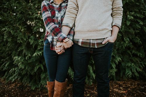 woman holding man hand