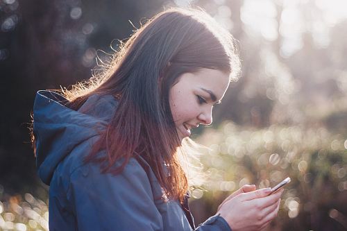 woman holding phone smiling