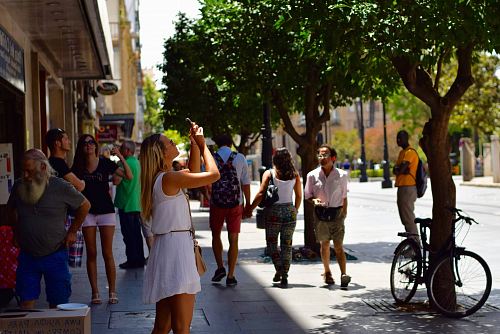woman holding smartphone near man wearing gray t-shirt