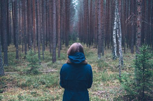 woman in hoodie at forest