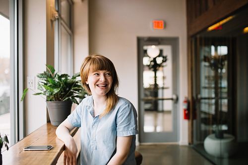 woman sitting in front of brown wooden table