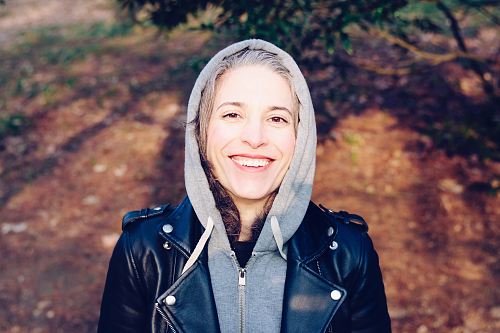 woman smiling near tree