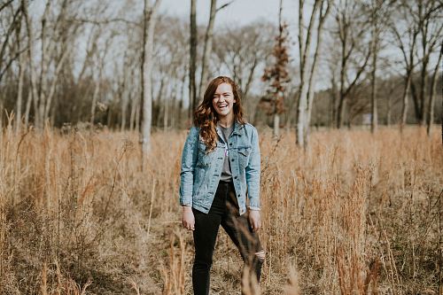 woman standing at forest while smiling