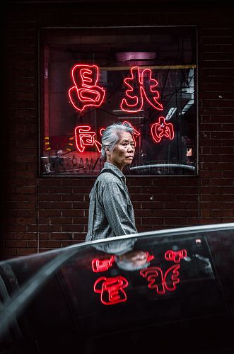 woman standing in front of glass store