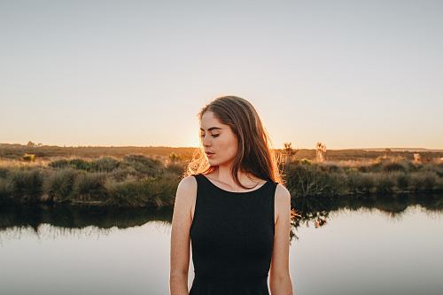 woman standing near pond