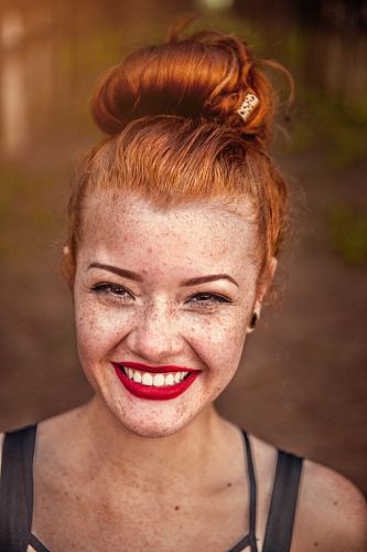 woman taking photo while showing smile