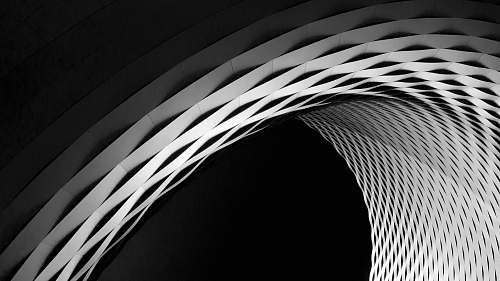 black-and-white A curve in a latticework facade in black and white arched