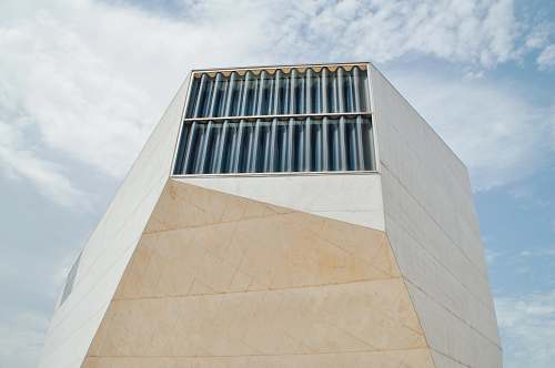 building white concrete tall building under cloudy sky porto