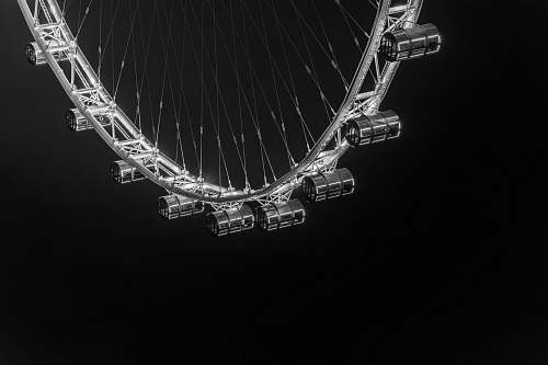black grayscale photo of ferris wheel during nighttime singapore flyer