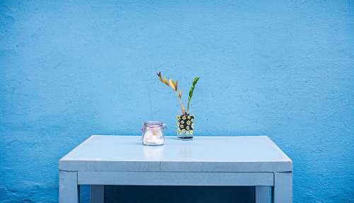 table clear glass jar on gray wooden table blue desk
