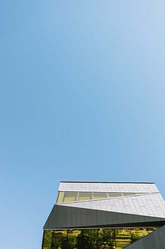 sky low-angle photography of white concrete building under clear blue sky building