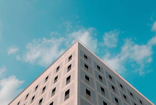 sky shallow focus photography of Library building under blue and white cloudy skies at daytime stuttgart