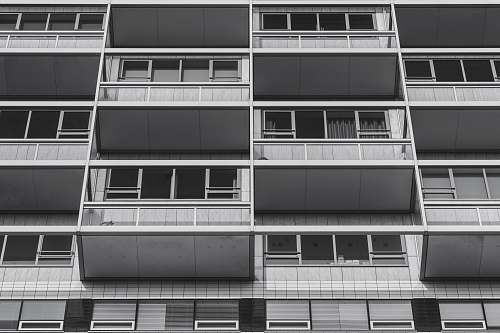 black-and-white worm's eye view of apartment complex balcony