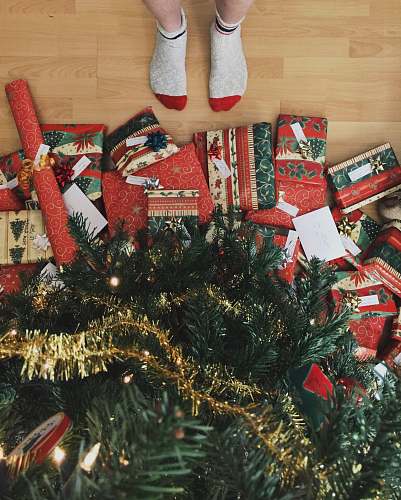 holiday person standing beside christmas tree gift