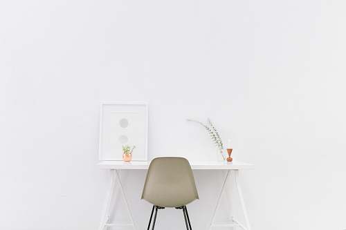 white white wooden table near brown chair office
