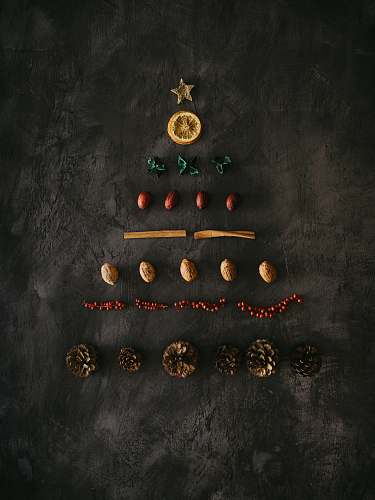 christmas assorted-color ornaments on black surface plant