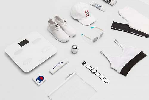 cap flat lay photography of shoes, sunglasses, cap, pants, and sport brassiere clothing
