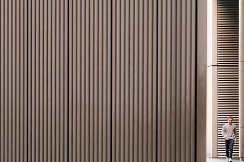curtain man walking towards gray wall home decor