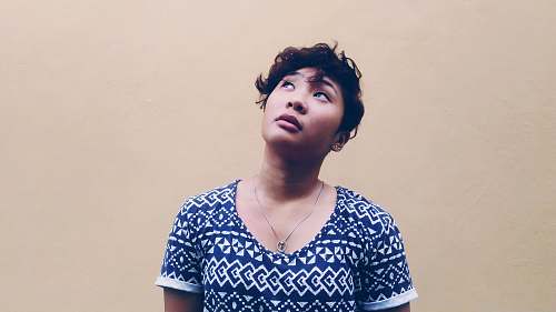 woman woman wearing black and white shirt looking above portrait