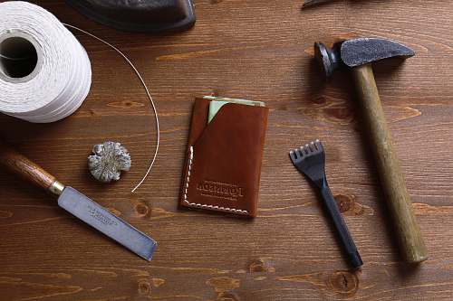 tool hammer beside brown book knife