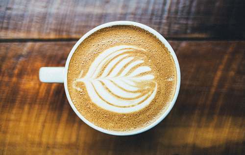 drink capuchino on white ceramic mug coffee cup