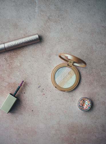grey opened compact powder and lipstick makeup