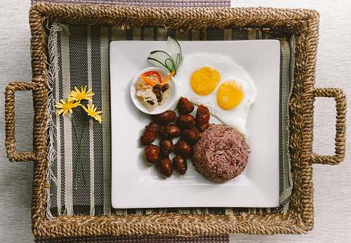 meal plate of foods on brown wicker tray breakfast