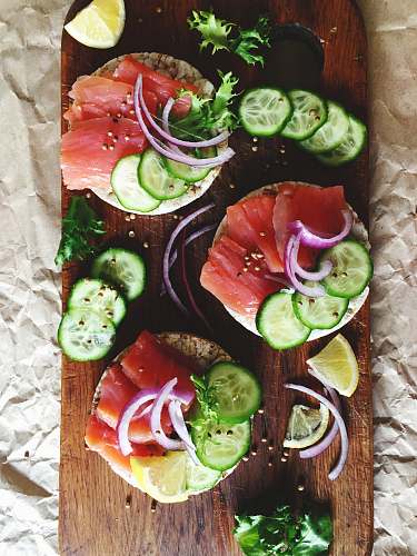 flatlay raw fish filet with vegetable and spices on chopping board flat lay