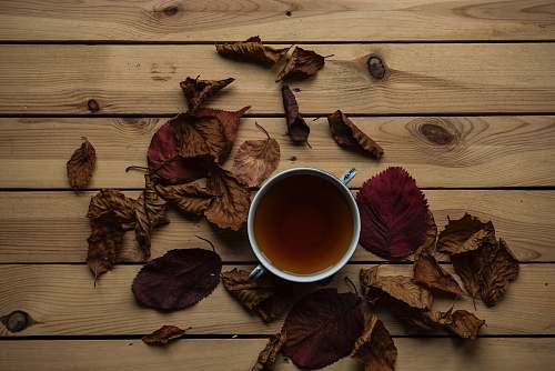 bowl tea in cup on brown wooden surface tea