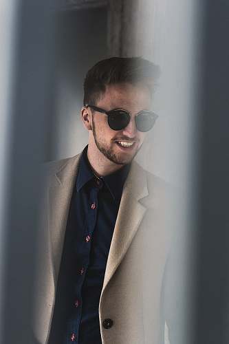 human man standing beside wall person