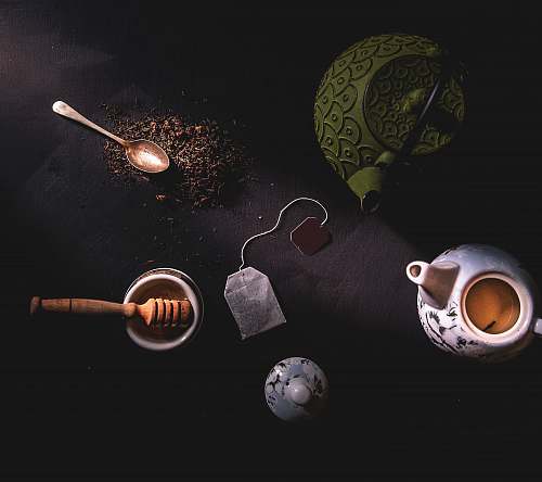 food two teapots beside mortar and pestle cup