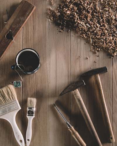 brown two hammers beside screwdriver worktop
