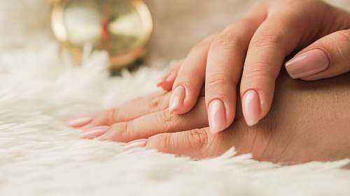  persons hand on white textile 